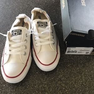 White Converse slip-on sneakers